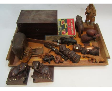 A mahogany tea caddy and a wooden tray of various carved wooden figures
