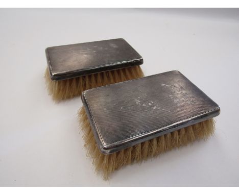 A pair of silver stamped Birmingham, Art Deco gentleman's brushes with engine turned decoration