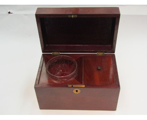 A Victorian mahogany tea caddy with glass insert and tea space