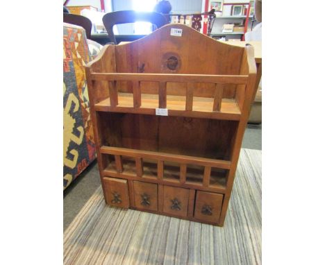 A rustic pine kitchen spice rack with four drawers