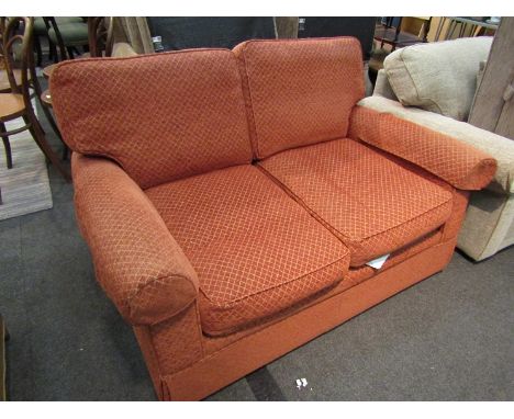 A Marks &amp; Spencers two seater sofa in terracotta coloured upholstery 