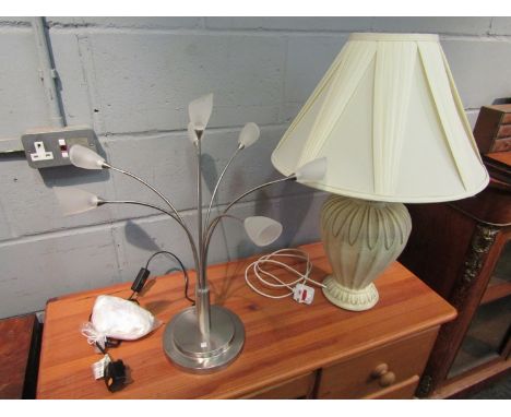 A ceramic table lamp with leaf design and cream pleated shade, with another lamp