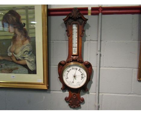 An Edwardian oak barometer with carved detail,  84cm tall