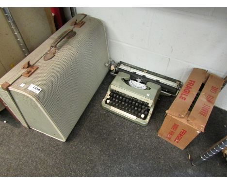 A cased Hamfa sewing machine, an Imperial typewriter and a projector and screen