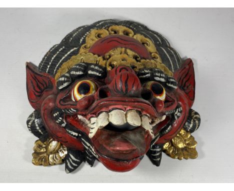 A VINTAGE CARVED WOODEN TRIBAL DRAGON MASK 