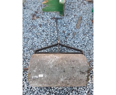 A CONCERETE GARDEN ROLLER WITH WROUGHT IRON HANDLE 