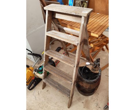 A VINTAGE FOUR RUNG WOODEN STEP LADDER AND A BARREL STYLE WATER FEATURE 