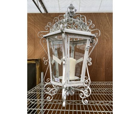 A SCROLLED METAL OUTDOOR CANDLE LANTERN 
