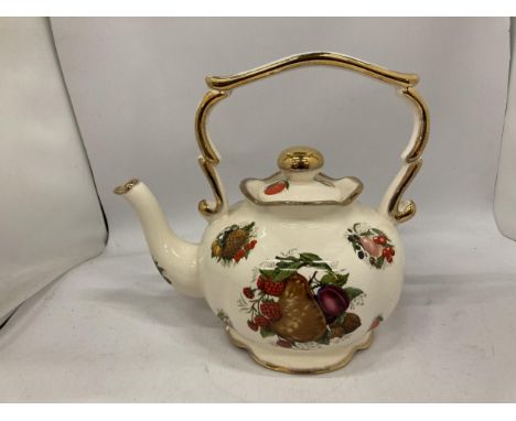 A LARGE CERAMIC KETTLE WITH FRUIT DECORATION 