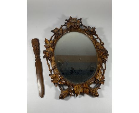 A VINTAGE CARVED WOODEN MIRROR WITH MATCHING LETTER OPENER, MIRROR LENGTH 40CM 