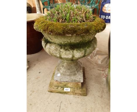 A RECONSTITUTED STONE URN PLANTER 