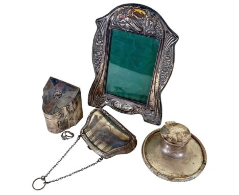 An early 20th century decorative silver photo frame, 13cm x 9cm opening, a silver inkwell, a silver purse and a silver miniat