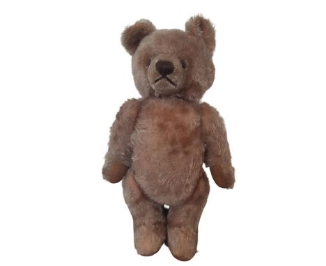 A teddy bear by Steiff with pin in ear, clipped muzzle and weak voice box. Height 32cm