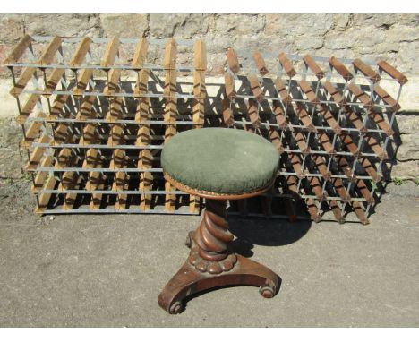 A Victorian rosewood piano stool with circular revolving seat, together with two wine racks