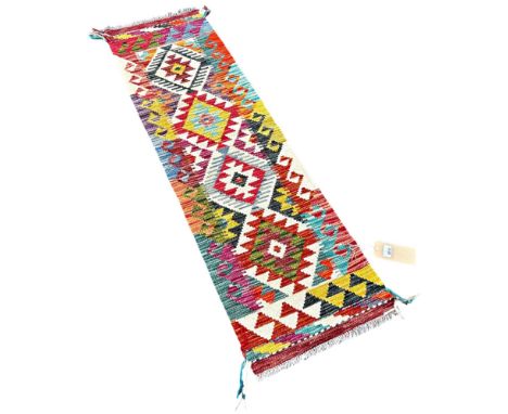 A narrow Chobi kilim runner with a single row of stepped medallions 148cm x 42cm approximately 