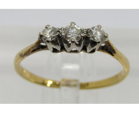 18ct platinum set three stone diamond ring, centre stone 0.10ct approx, size O, 1.6g