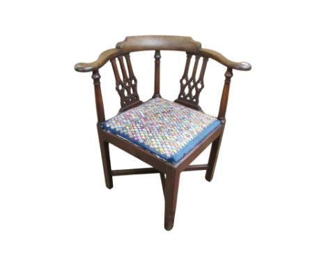 A Georgian mahogany corner armchair with pierced gothic tracery splats and hand worked tapestry seat