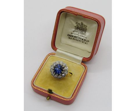 Mid 20th century 18ct claw set sapphire and diamond cluster ring, the sapphire 2.25ct approx, diamonds 0.05ct each approx, si