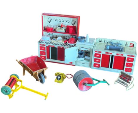 Two tin doll’s house kitchen units and a matching fridge and some die cast garden equipment lawn mower, lawn roller, wheelbar