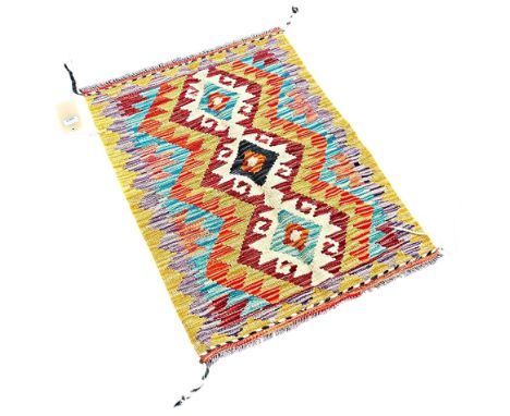 A Chobi kilim mat with a central row hooked medallions 86cm x 62cm approximately 