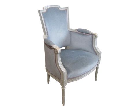 A French drawing room chair in pale blue upholstery within a shaped carved and moulded show wood frame, with painted finish