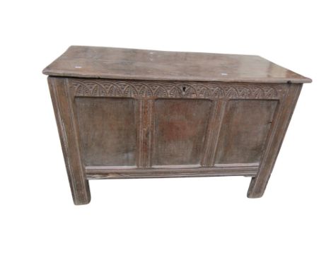 An 18th century country oak coffer with lunette carved frieze, notch carved hinged cover revealing a vacant interior, 71 cm h
