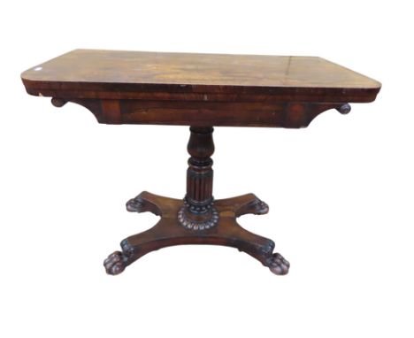 A Regency rosewood D end fold over top card table on turned and carved pillar, platform base and lions paw feet, 75cm high x 