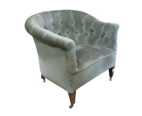 A late Victorian/Edwardian green dralon upholstered tub chair with button back raised on square tapered forelegs with brass c