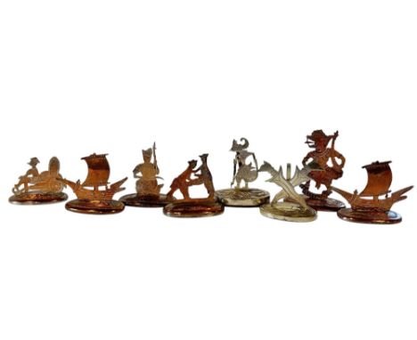 Eight worn Indonesian silver plated menu holders, depicting Kris, shadow puppets, dancers, wrestlers etc together with an Art