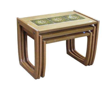 A mid-20th century graduated nest of three occasional with inset glazed tile tops 
