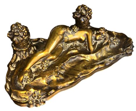 After Paul Philippe, a gilt cast metal twin inkwell decorated with an erotically modelled female nude in bacchanalian slumber