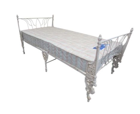 A 19th century cast iron folding single bed with decorative end supports with mattress to accept a 3ft mattress 