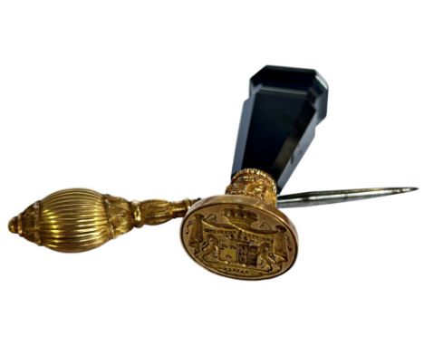 An 18th century seal with agate handle and a further yellow metal military hat pin (2)