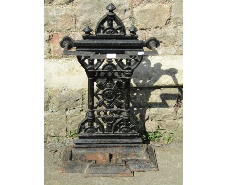 Late Victorian cast iron umbrella stand and a large vintage style wicker laundry basket with twin loop handles, 46cm high, 80