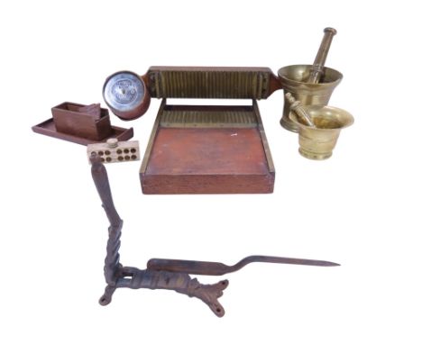A 19th century wooden and brass pill maker, two brass pestle and mortars, a clamp etc together with a Middle Bank money box.