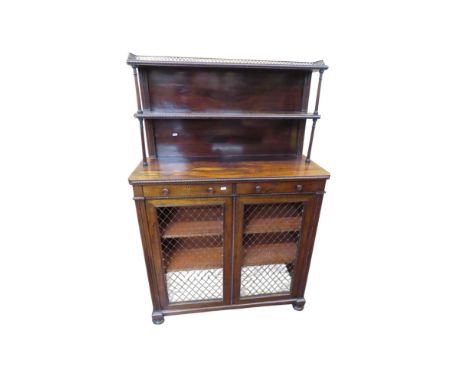 A Regency rosewood chiffonier the base enclosed by a pair of brass grill doors and two frieze drawers, with raised and shelve