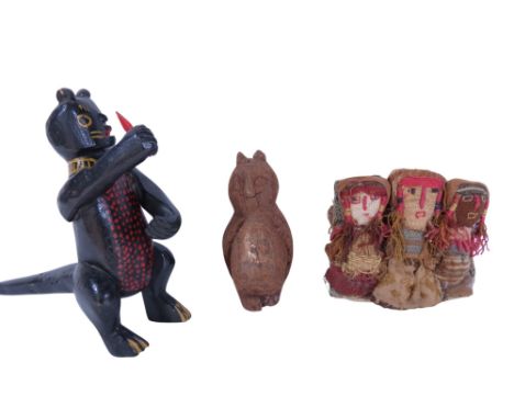 A Costa Rican carving of an owl, a Mexican carving of a Howler Monkey eating mango and a Peruvian set of dolls made from pre-
