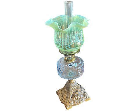 A Victorian oil lamp with vaseline glass shade on a later gold painted iron base. 