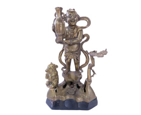 A Chinese bronze statue of a Hoho twin holding a vase 36cm high, (with later light switch to rear base.)