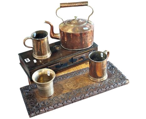 A collection of 19th century copper and brass ware including tankards, a pestle and mortar, a copper kettle, a set of scales 