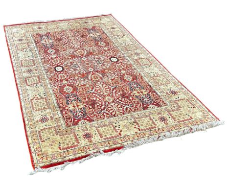 A Persian style rug with a red and cream all over floral pattern 215cm x 140cm approximately 