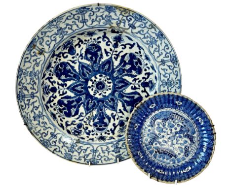 Two Chinese blue and white porcelain dishes to include a large charger with floral and auspicious decorations, bearing a Kang
