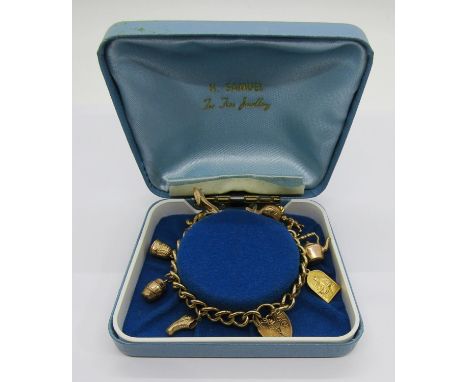 Vintage 9ct charm bracelet with engraved heart padlock clasp, hung with nine novelty charms to include a stiletto, a boot, du
