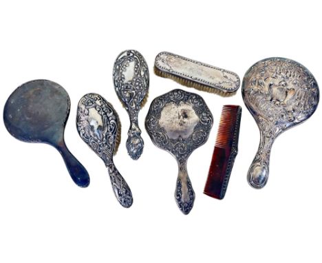 A selection of silver backed hand mirrors, brushes and a comb, (all af)