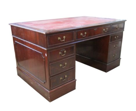 A large reproduction mahogany kneehole twin pedestal desk fitted with an arrangement of eight drawers disguised as nine, 79cm