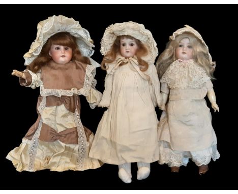 Three small German bisque head dolls early 20th century comprising a mould 390 doll by Armand Marseille with blue closing eye