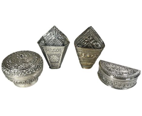 A mixed selection of Thai silver, including two open kite shaped Betel holders, a richly engraved circular Betel box and a cr