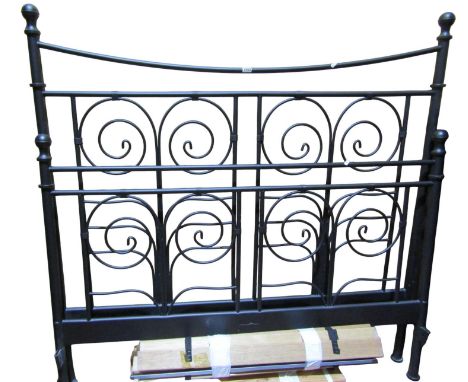 A contemporary black iron bedstead to accept a 4ft 6 mattress the head and foot boards with scrolled details 