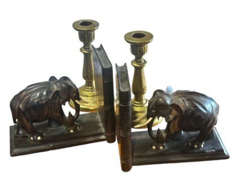 A pair of solid brass candlestick stamped E Grimstead to the base 16cm high and a pair of elephant bookends. 