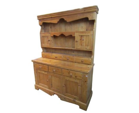 A large reclaimed pine kitchen dresser with enclosed rack over three drawers and cupboard doors, 187cm high x 138cm x 46cm